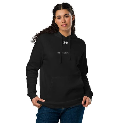 Person wearing a black hoodie with text and a logo on a white background
